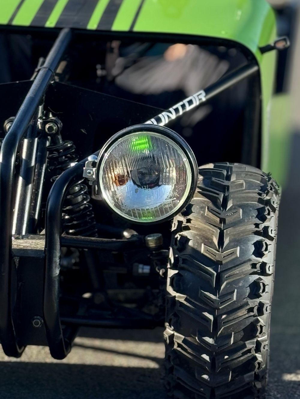 Close-up of a headlight and tyre