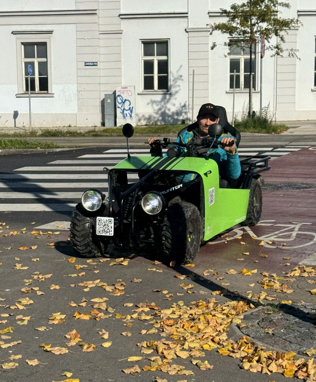 A rider in the green ride at a crossing
